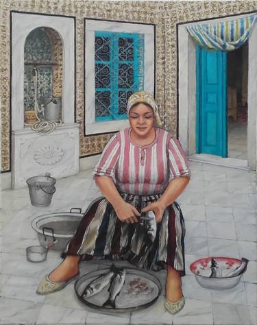 Woman preparing fish in a traditional Tunisian house thumb