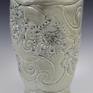 This is a ceramic vase made with porcelain and carefully hand carved with floral design. Covered with green celadon glaze, gas fired. It is water proof and can be used for flowers as well as decorative piece for your interior.