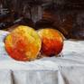 Still life with peaches and a white, simple cloth.