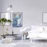 Blue white abstract artwork in a bright bedroom