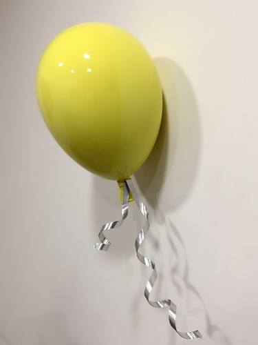 Wall mounted yellow balloon thumb