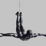 This sculpture hangs onto the wall with the help of a nail and it appears as if the figure is diving from the wall.