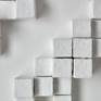 Skyscrapers / houses made from plaster of Paris. 
This piece represents a city, where someone can get easily carried away by its breath taking buildings. No matter how the light falls on it, shadows will appear within the piece.