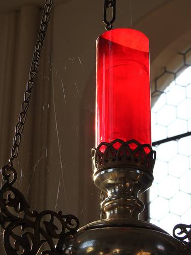 The red church candle with spider webs thumb