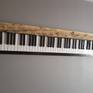 Many years of piano lessons when I was young seared the image of the piano keyboard forever in my mind. I like the contrast of the white and black keys and the overall simple yet definite design which will always be true.
     All of the keys - 52 white and 36 black are hand cut and sanded. The barnwood is cleaned and unfinished. Hanging hardwood is included.