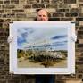Richard Heeps holding his print 'Grand Stand'.