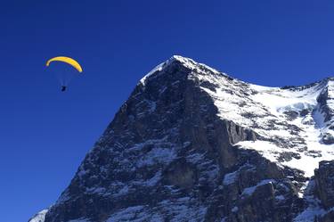 Paraglider near the North face of the Eiger mountain, Grindelwald Ski resort; Swiss Alps, Switzerland - Limited Edition of 20 thumb