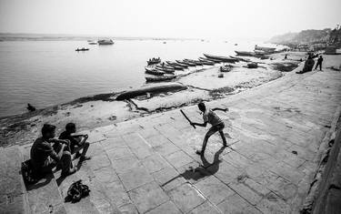 Boys playing cricket on the banks of the river Ganges thumb