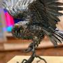This work was made of hot forged metal by me. Each feather was made manually. The body was made of iron. The body itself is airtight. The eyes were made of glass. The owl sits on its own in the snag. The snag was also made of metal. 
This work is no longer available. 
But I will gladly make one for you. There will be no exact copy. Since this is a handcrafted work. But I promise you, it will be no worse. I put my heart and soul into every art. In every art I do, there are only positive emotions.