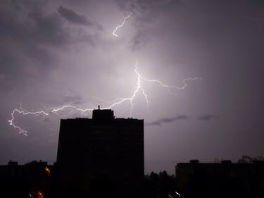 Lightning and thunder at night in the city it's raining thumb