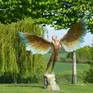 Icarus bronze sculpture in landscape.