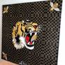 This painting is inspired by Gucci and its history. This painting contains the Gucci tiger that is made with gold leaf, red , white and black acrylic paint and gold spray for the Gucci Monogram.