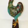 Cooper the Rooster measures 16 in T x 9in W x 8 in D.

He was created over a wire/cardboard armature using a special paper mache clay, lovingly hand painted with quality acrylic paints protected with a matte enamel finish. 

A great addition to your chicken collection :-)
