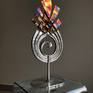 A unique piece that was inspired by the beauty of fire. The piece is coloured using heat after the Stainless steel has been electro polished. It is suitable for outside.