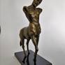 A brass sculpture of a mythical centaur standing tall.