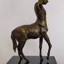 A brass sculpture of a mythical centaur standing tall.