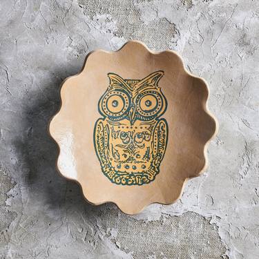 Green owl on a yellow ceramic bowl thumb