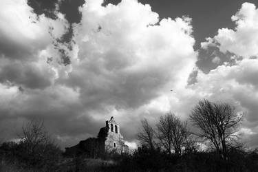 Abandoned church under the clouds thumb