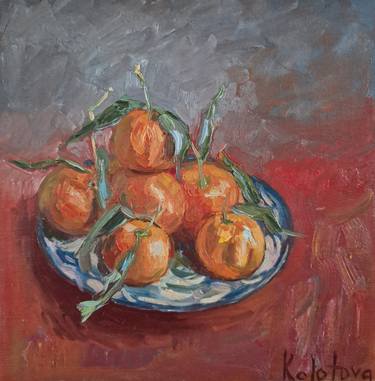 Tangerines on red thumb