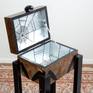 On the floor standing decorative object expressing a spider, the Black Widow. A dangerous animal, only for the brave !??! But don't be afraid. This box made of wood and covered with metallic foil won't bite you.Inside in the cobweb there is room to put some of your nicest belongings.