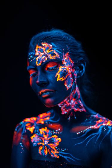 Beautiful flowers in UV light on a young girl face and body thumb