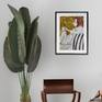 painting on wall with large plant and chair