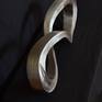 The work was inspired by the infinity math sign, it was a one dimensional sign, I made it into a three dimensional figure.
     I want people to think about endlessness, something beyond themselves, beyond everything, hard to grasp.
    I chose stainless steel because it's rate of oxidation is slow.