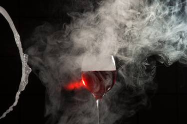 Glass of wine with smoke. thumb