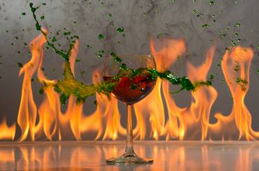 Wine glass with splash and flames. thumb