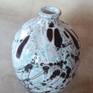 Decorative vase is made on a Potter's wheel and decorated with colored glazes. Cone 5.