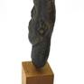 A sculpture made by the method of pressed brass.
With black patina, mounted on a wooden base.