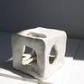 The cube series is an exploration of movement, shape and sculpture in 3D form. The cube has an organic cut out on every side letting in air and light, acting not like a container but a vessel for movement.