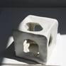 The cube series is an exploration of movement, shape and sculpture in 3D form. The cube has an organic cut out on every side letting in air and light, acting not like a container but a vessel for movement.