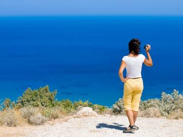 Young woman filming the beautiful Mediterranean sea thumb