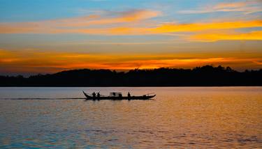 A boat with fishermen in the middle of the river in the beautiful colors of the sunset, Cambodia - Limited Edition of 10 thumb