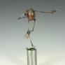 Egg is made from cast polymer resin.  limbs are hand fabricated form copper tubes and wires.  Articulable joints  are made from copper disks with over 100 hand punched holes to capture desired posture, then sealed permanently with fixative.