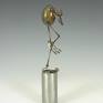 Egg is made from cast polymer resin.  limbs are hand fabricated form copper tubes and wires.  Articulable joints  are made from copper disks with over 100 hand punched holes to capture desired posture, then sealed permanently with fixative.