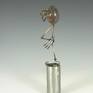 Egg is made from cast polymer resin.  limbs are hand fabricated form copper tubes and wires.  Articulable joints  are made from copper disks with over 100 hand punched holes to capture desired posture, then sealed permanently with fixative.