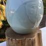 Handcrafted in porcelain with application of blue Celadon glaze. A unique piece of art, fired at 1300 degree C.

The art work comes with an  wooden base.