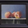 Three peaches on a table with a simple tan cloth. The soft texture and multiple colors on each fruit create marvelous shadows.