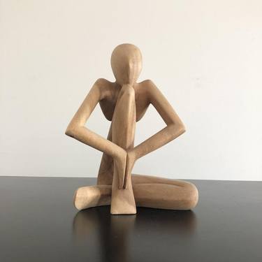 wooden abstract sculpture of a sitting man thumb