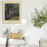 framed figure art hung in living room olive tree