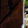 Details of key to Tuscan house old wooden door painted with knife