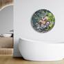 Lollipop, a round painting celebrating the innocence of youth, a young boy sits on a rock looking into a river. His nude figure is surrounded by tree leaves, increasing his alone time in nature. Shown here with an elegant bathroom featuring a round window.