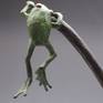 Detail of the back side of the hanging bronze frog, he is green patina, the cattail is traditional bronze finish