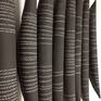 This wall installation is made up of several ceramic elongated shapes, made in black clay and individually decorated with various imprints and patterns, the work can be sold as individual pieces or as multiples