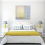 Intersect in a light and sunny bedroom with blue and yellow color accents.