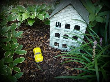 Yellow toy car in the garden, artistic photo thumb