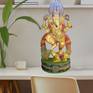 Lord Ganesha, the elephant-headed Hindu god of beginnings, is traditionally worshipped before any major enterprise and is the patron of intellectuals, bankers, scribes, and authors.
This ancient Lord is skillfully recreated by hand in Mahogany wood and colored with Acrylics by this skillful creator, making this a colorful and spiritual addition to your space.
70013-OR-RAC
