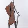The steel sculpture "Knight on Guard" loosely follows my previous silhouette and figural stylizations. However, the overall tone is different both in the form of stylization of the body and the focus on the small details that are decisive for the artwork and which are characteristic of the image of a knight.
The theme itself, the figure of a knight on guard, is not an image of a warrior, but a knight for whom honor and pride were something for which he was willing to die. The theme is the guardian of honor, loyalty and honesty.
An old rusted sheet metal is used on the body, which is partially embossed so that the surface sculpture is completed by shadows. The other parts are forged.
The sculpture is signed on the base.